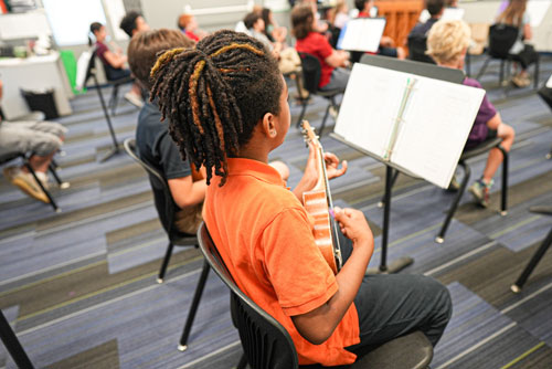 A scholar playing a violin after