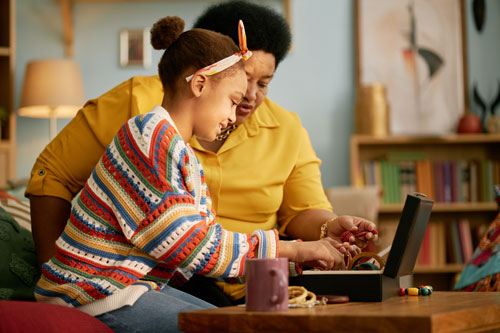 Grandmother and Granddaughter learning online