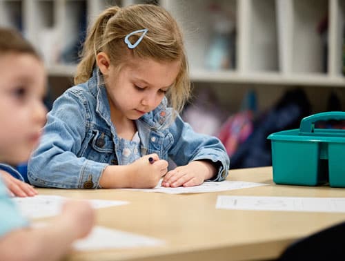 A young scholar in preschool learning through fun activities
