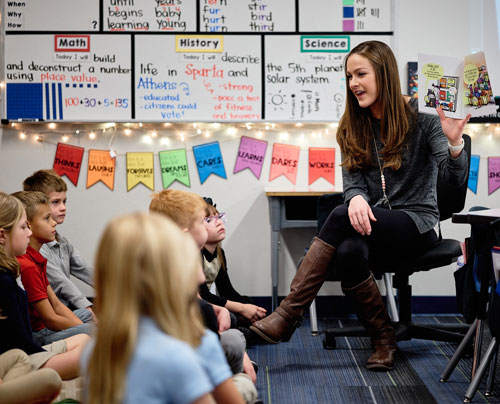 Leman East PreK teacher reading a story book to her class