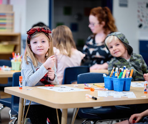 Two preschoolers getting ready to draw in Marana preschool