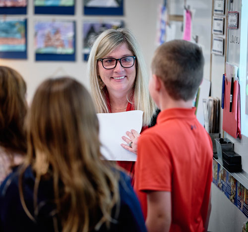 Teacher at Oro Valley Preschool Surrounded by Scholars