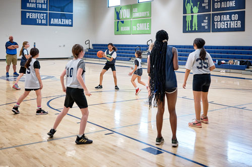 Scholars playing basketball in the MPR at Leman Academy in Sierra Vista