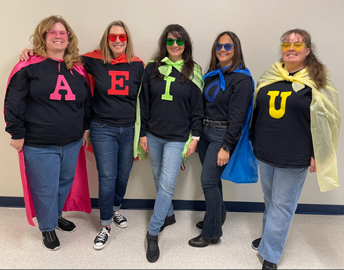Teachers at Leman Academy dressed as super vowels