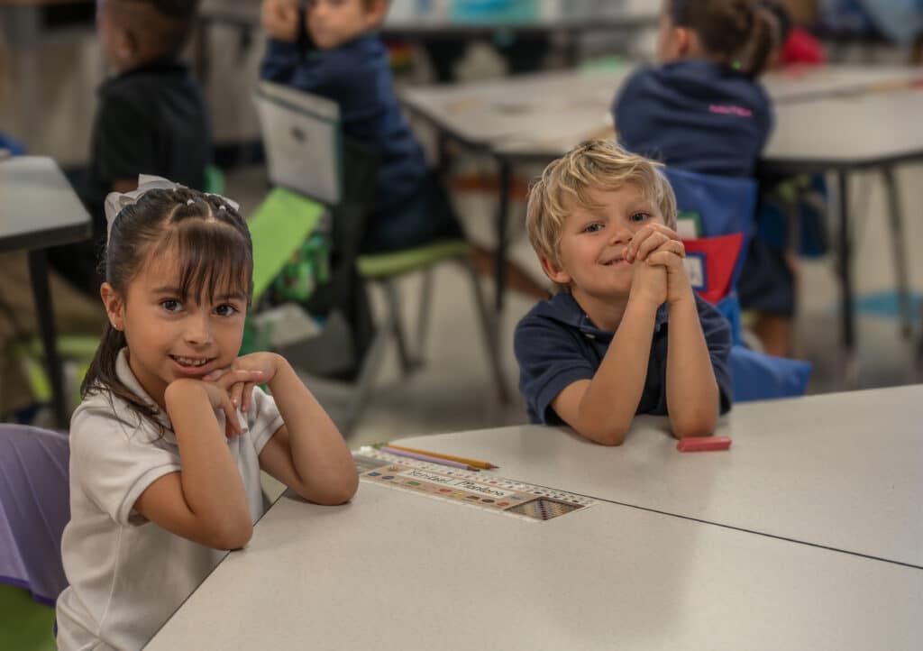 Kindergarten scholars smiling confidently in a structured classroom at Leman Academy