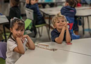 Kindergarten scholars smiling confidently in a structured classroom at Leman Academy