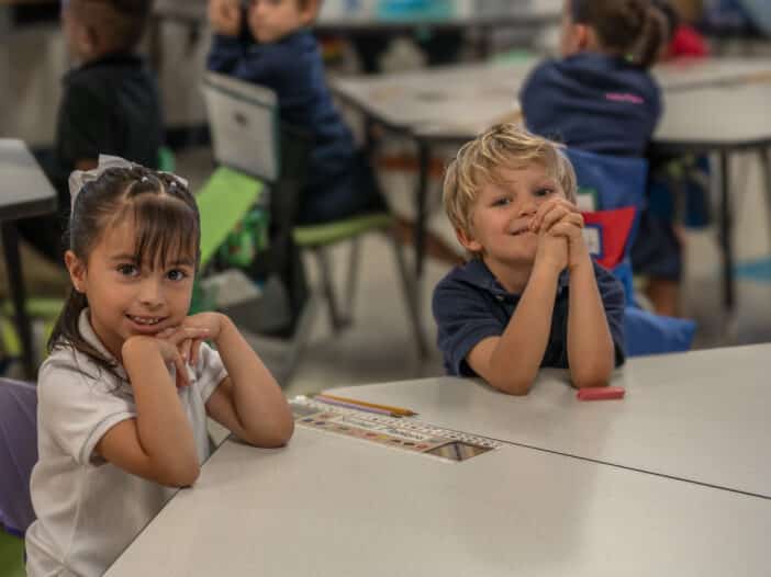 Kindergarten scholars smiling confidently in a structured classroom at Leman Academy