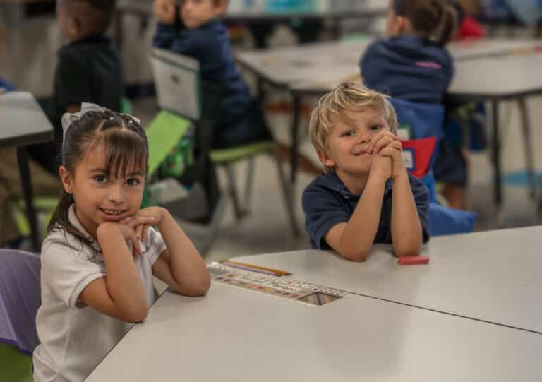 Kindergarten scholars smiling confidently in a structured classroom at Leman Academy