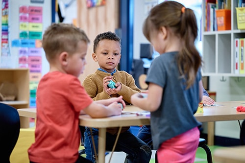 Preschool scholars working in small groups