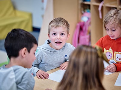 Young children interacting and playing together in a preschool classroom setting