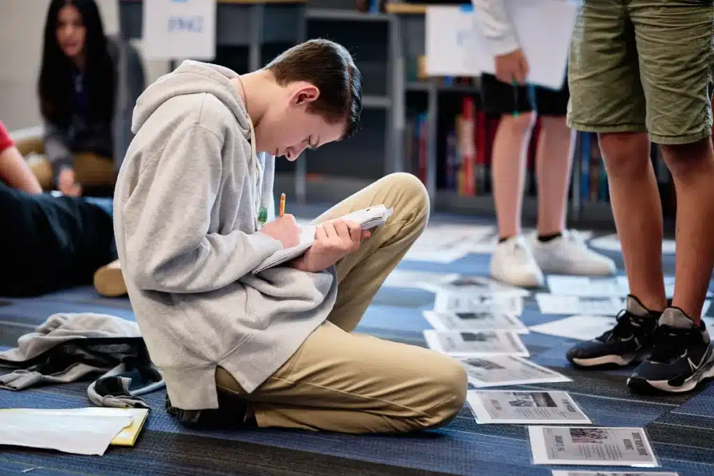 A student in class, receiving a classical education at a Leman Academy school