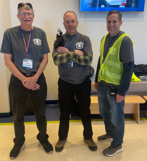 Three Watch D.O.G.S. standing in the hall of Leman Academy