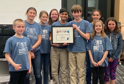 academic success image with scholars holding an award